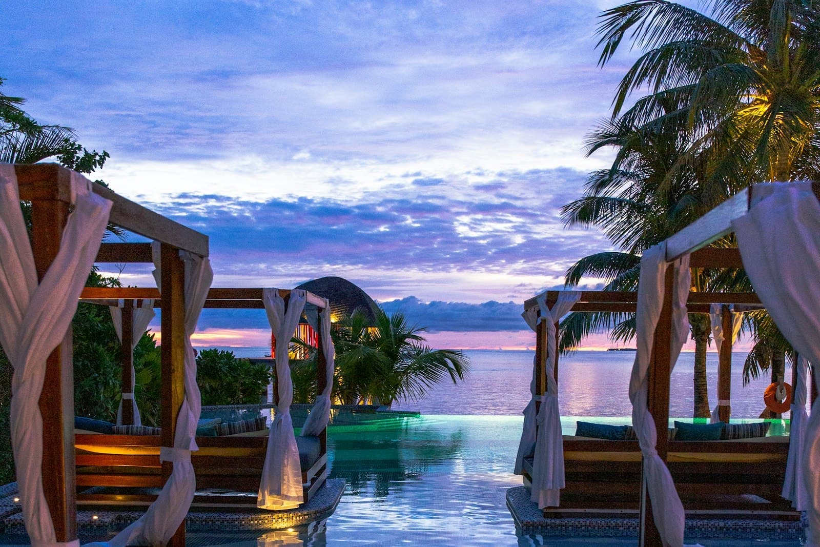 The infinity pool at dusk, set at the edge of the bank looking upstream